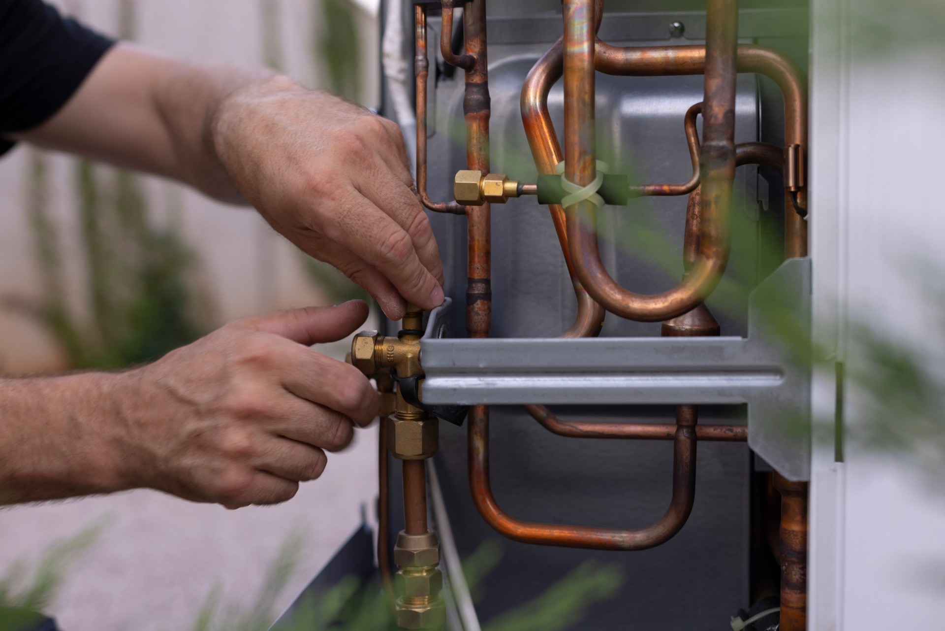 Close-up shot of an electrician installing a heat pump